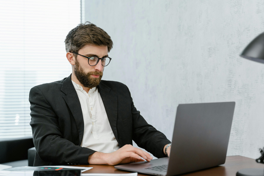 Tech guy on a laptop in office