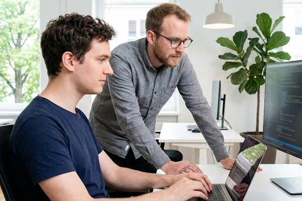two-guys-working-on-computers Two guys working on a computer together